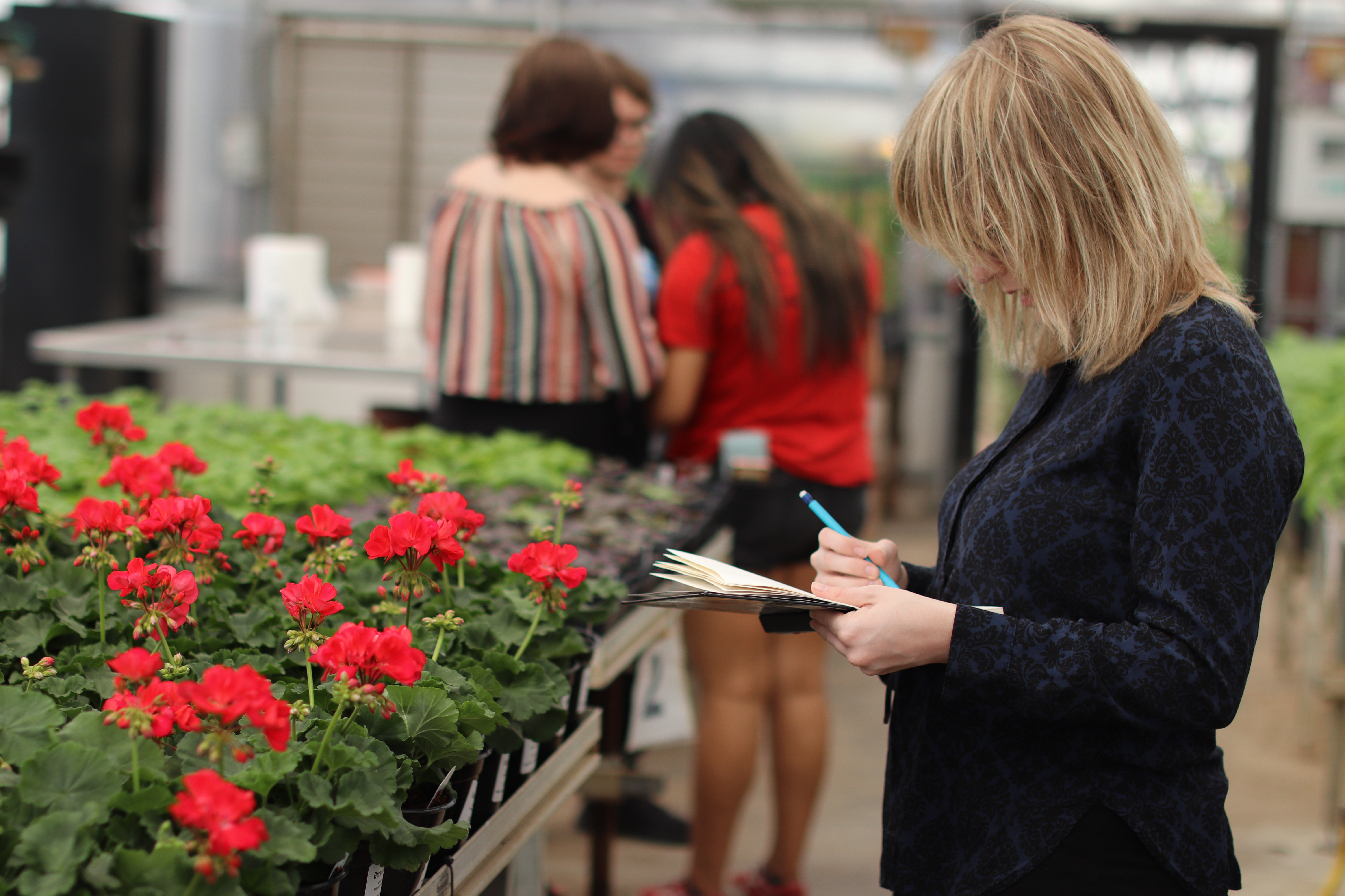 Photo of Woman sketching the flowers.